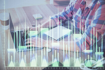 Multi exposure of forex graph with man working on computer on background. Concept of market analysis.