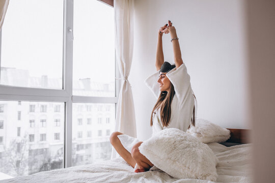 Woman In Bed Wearing Sleeping Mask