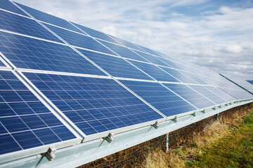 Solar power panel on blue sky background, alternative clean green energy concepts.