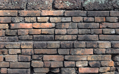 Fototapeta premium The orange old brick wall of the ancient building
