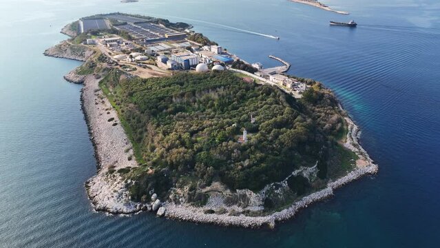 Aerial drone video of small industrial island of Psitaleia the largest sewage treatment plant in Europe, Saronic gulf, Peiraeus, Attica, Greece