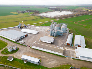 silver silos on agro manufacturing plant for processing drying cleaning and storage of agricultural...