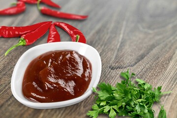 Spicy paste or sauce in bowl with paper