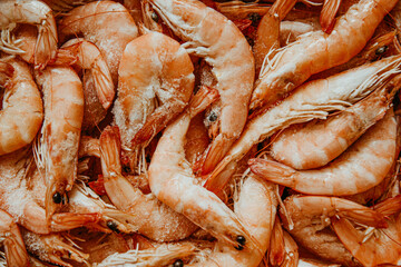 Shrimps are frozen in large quantities, seafood is fresh, many with ice. Fresh shrimps, fish department