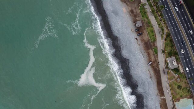 A beautiful beach with waves near the city's waterfront. Lima, Peru