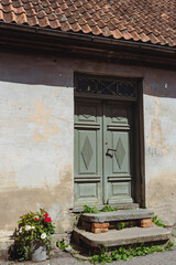 Fototapeta na wymiar old green wooden door in a village