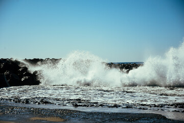 Water hits stones, waves on the sea or ocean. Summer and rest.