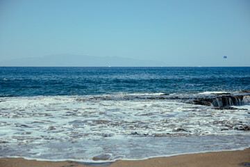 Water hits stones, waves on the sea or ocean. Summer and rest.