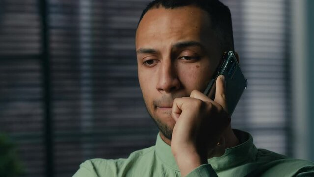 Serious worried excited latin american man talking mobile phone sad frustrated confused young businessman hear bad news feel stress experience have problem unpleasant remote conversation on smartphone