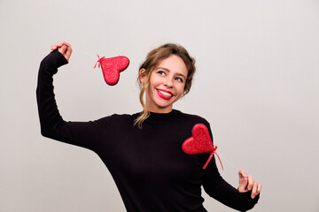 Woman in black with red hearts in hands