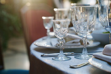 empty wine glasses on the table.table setting for a festive dinner. solar glare.
