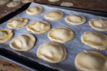Raw puff pastry dumplings on a oven tray
