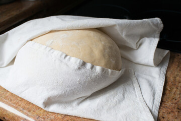 Yeast dought with a table cloth waiting to rise
