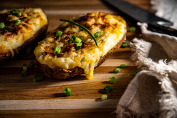 Cheesy twice-baked potato garnished with chopped scallion