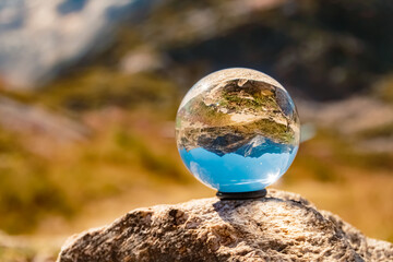 Crystal ball alpine summer landscape shot at the famous Weisssee Gletscherwelt, Uttendorf, Salzburg, Austria