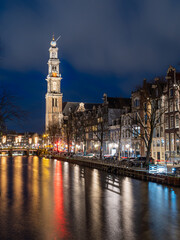 Fototapeta premium Night view of the western church from canal in Amsterdam.