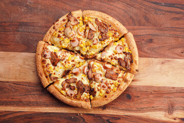 Freshly baked american pan pizza with a lot of cheese, chicken sausage, thin and crispy kebab meat...