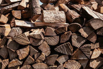 Chopped firewood is stacked in a big pile