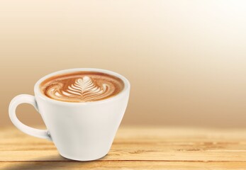 Cup of tasty sweet hot coffee on desk