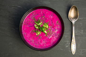 Tasty summer soup chlodnik or holodnik on black background, top view. Served table. 