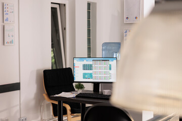Computer monitor with internal trading process software investment on screen. Empty office with stock market listing displayed on desktop computer, forex investment concept.