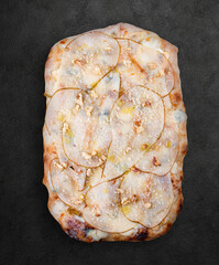 Pizza Gorgonzola with pear, walnuts, syringa sauce, truffle oil. Roman pizza rectangular on dark background