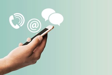 Person holding a phone and icons for chat.