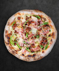 Pizza Carbonara with bacon, chanterelles, arugula, mozzarella, parmesan, pesto. Neapolitan round pizza on wood background