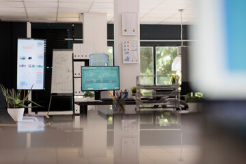 Modern software that analyzes sales data chart growth in a modern strategy interface. Online digital financial statistics company with empty workstations at the end of the working day.