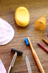 Various zero waste beauty products and kitchen utensils on wooden background. Selective focus.