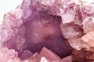 Macro focused vibrant pink amethyst quartz geode crystal, rose hematite amethyst points isolated on a white background surface - obrazy, fototapety, plakaty