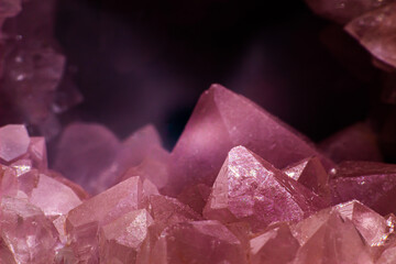 Fototapeta premium Macro focused vibrant pink amethyst quartz geode crystal, rose hematite amethyst points isolated on a white background surface