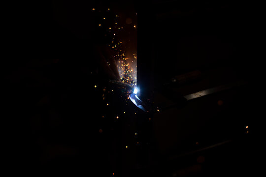 Metal welding in dark High temperature heating steel. Metal lights.