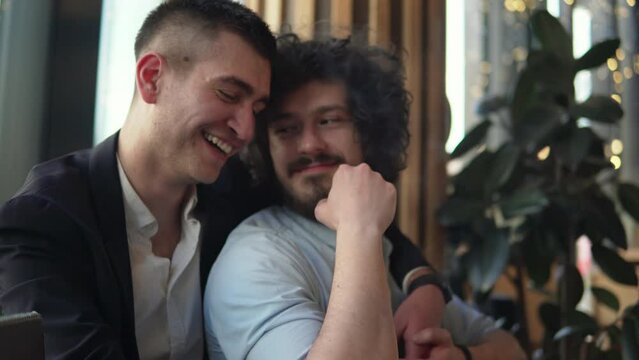 Homosexual Gay Couple hugging and Kissing while in a cafe shop, lgbt and love concept
