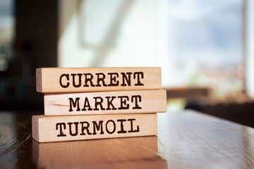 Wooden blocks with words 'Current market turmoil'.
