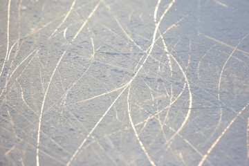 bright traces of ice skating on an ice rink. background and texture