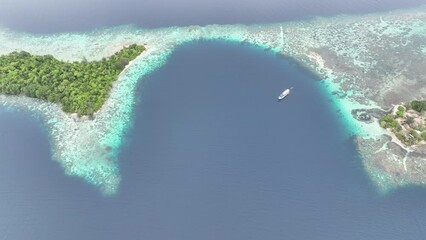 A beautiful coral reef surrounds a scenic bay in the Solomon Islands. This beautiful country is home to spectacular marine biodiversity and many historic WWII sites.
