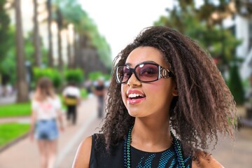 Happy young woman walking in city