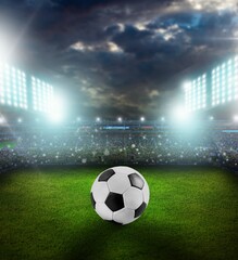 Fototapeta premium Classic soccer ball in big field stadium.