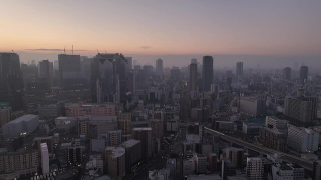 Aerial view of tall modern buildings in central Osaka on smoggy morning