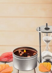 Beautiful aroma candle and autumn leaves