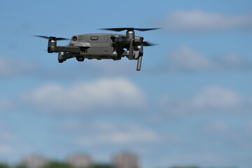 Fototapeta na wymiar Gray quadcopter in flight. Photo-video aerial photography.