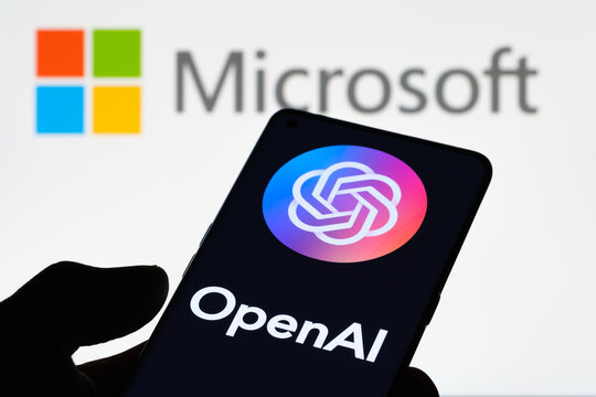 OPENAI logol seen on smartphone and laptop display with MICROSOFT logo on the background. Concept. Stafford, United Kingdom, January 11, 2023
