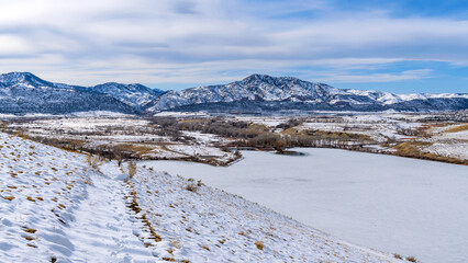Fototapeta na wymiar Winter Park - A bright sunny Winter day overview of snow-covered Bear Creek Lake Park, as seen from Mt. Carbon. Denver-Lakewood-Morrison, Colorado, USA.