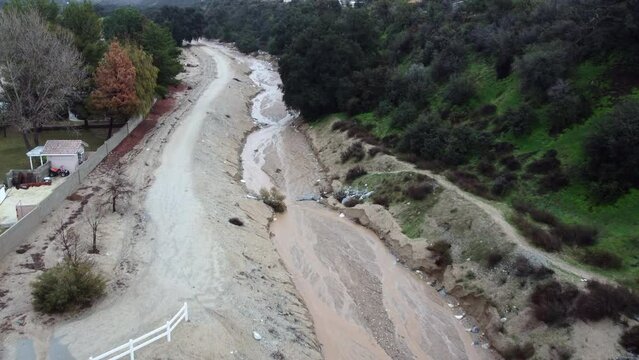 Flood Runoff Channel used to prevent Flooding with active Water flow from a Recent Storm in Oak Glen, California
