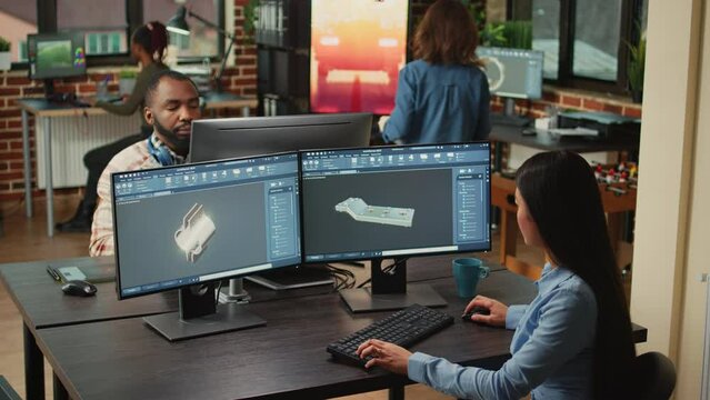 Engineering worker developing industrial component prototype on professional cad software, improving machine clamp. Asian graphic technician sketching 3D product or component, creative industry.