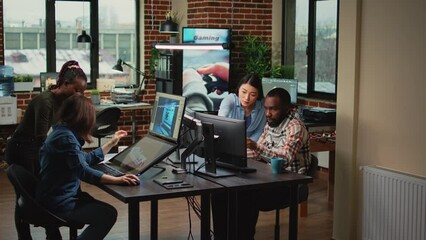 Modern technology studio employees using computers to develop new graphics interface in office, doing teamwork to create professional content. Working with 3d software to render on pc. - Powered by Adobe