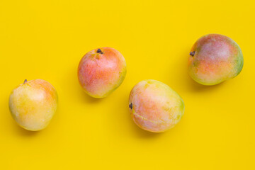 Tropical fruit, Mango on yellow background. Top view