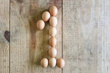 Number one written with chicken eggs, arranged on a rustic pine wood base, ideal for use in Easter numerals.