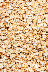 Raw organic oatmeal, food background texture, top view
